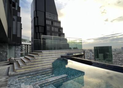 Modern high-rise building with rooftop infinity pool