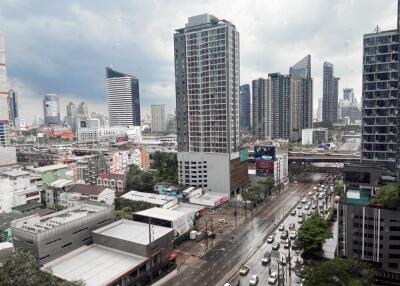 City view with high-rise buildings and traffic on a rainy day