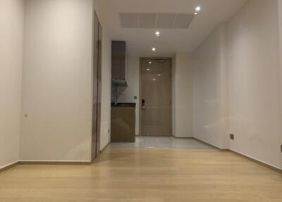 Main living space with wooden flooring and recessed lighting.