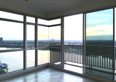 Modern living room with large windows offering city and river views