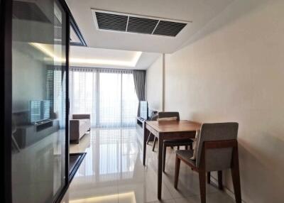 Modern living room with dining table and large windows