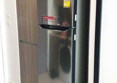 Modern kitchen with stainless steel refrigerator