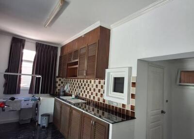 Modern kitchen with dark countertops and checkered backsplash