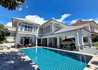 Exterior view of a modern two-story house with a swimming pool