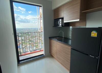 Modern kitchen with wooden cabinets and balcony view