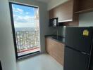 Modern kitchen with wooden cabinets and balcony view