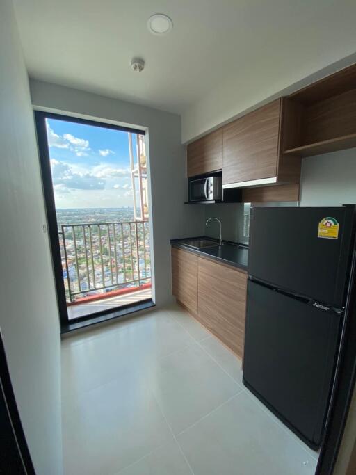 Modern kitchen with wooden cabinets and balcony view