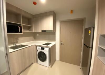 Modern kitchen with built-in appliances and washing machine