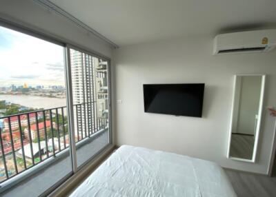 Bedroom with a balcony view and modern amenities