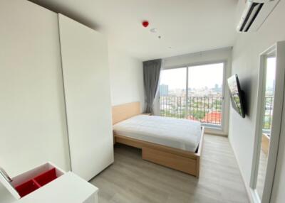 modern bedroom with large window and city view