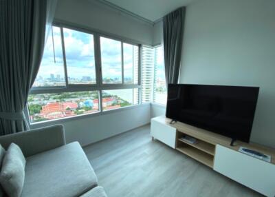 Living room with large window and impressive city view