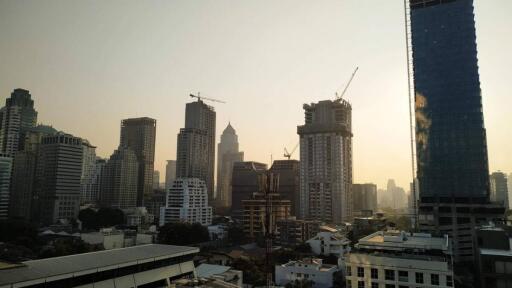 City skyline with skyscrapers under construction during sunset