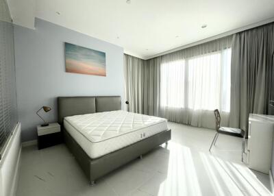 Spacious bedroom with large windows and natural light