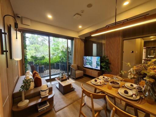 Cozy and modern living room with dining area and view of a balcony