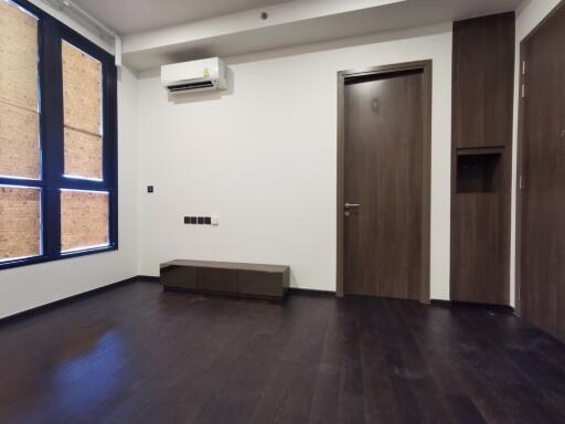 Modern living room with dark wooden floor and window shades