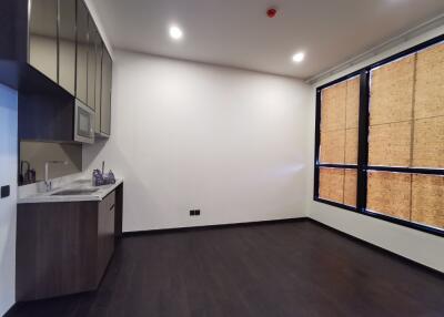 Minimalist kitchen with dark wooden floors and cabinetry