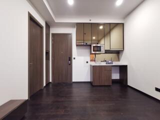 Compact modern kitchen area with dark wood flooring