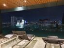 Night view of city skyline from a modern balcony