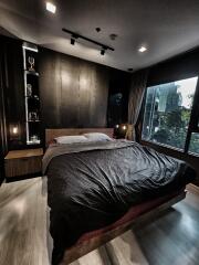 Modern bedroom with large window and wooden decor