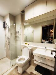 Modern bathroom with glass shower door and white fixtures