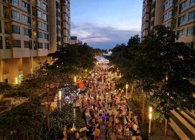 Crowded pedestrian street between residential buildings