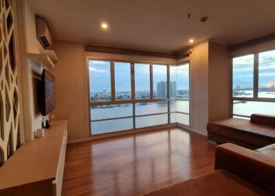 Modern living room with large windows and river view