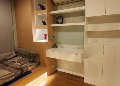 Bedroom with built-in shelves and a bed