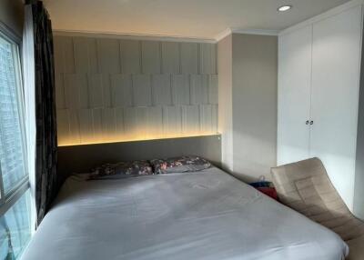 Spacious modern bedroom with large bed and walk-in closet