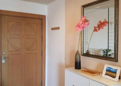 Well-decorated entryway with wooden door and modern decor