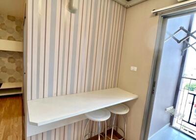 Contemporary styled corner with a wall-mounted table and stools near a balcony door