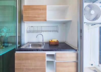 Modern compact kitchen with wooden cabinets and marble countertop