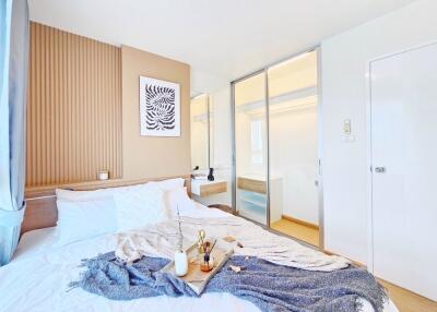 Cozy modern bedroom with large bed, decorative items, and sliding closet doors