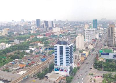 Aerial view of a city with buildings, roads, and green areas