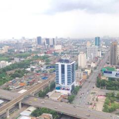 Aerial view of a city with buildings, roads, and green areas