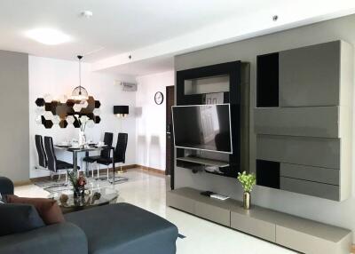 Modern living and dining area with wall-mounted TV and contemporary furniture