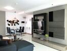 Modern living and dining area with wall-mounted TV and contemporary furniture