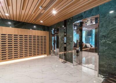 Modern building lobby with mailboxes and marble flooring