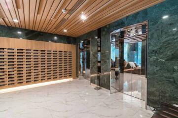 Modern building lobby with mailboxes and marble flooring