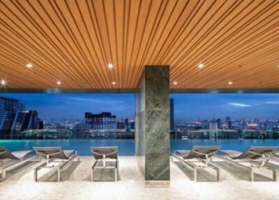 Outdoor pool area with lounge chairs and city view