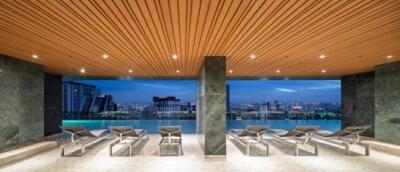 Outdoor pool area with lounge chairs and city view