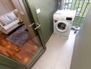 Enclosed laundry area with washing machine and access to living area