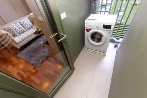 Enclosed laundry area with washing machine and access to living area