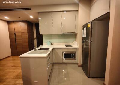 Modern kitchen with stainless steel appliances and glossy cabinets