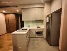 Modern kitchen with stainless steel appliances and glossy cabinets