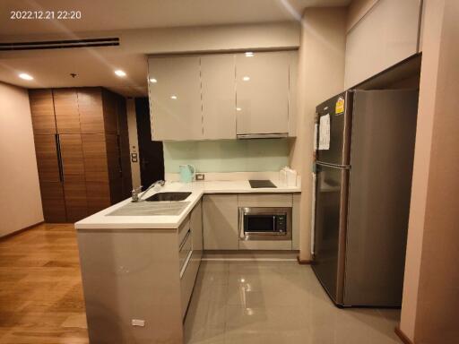 Modern kitchen with stainless steel appliances and glossy cabinets