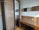 Bedroom with wooden wardrobe and dressing area