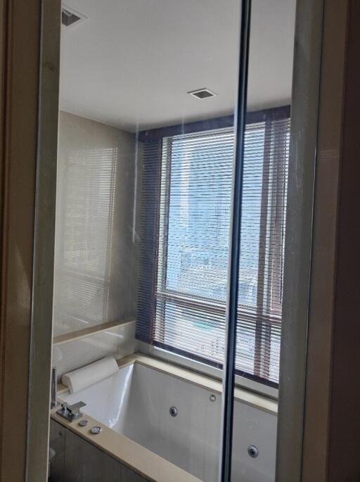 Modern bathroom with a large bathtub and window blinds