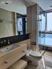 Modern bathroom with glass shower and countertop sink