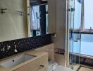 Modern bathroom with glass shower and countertop sink