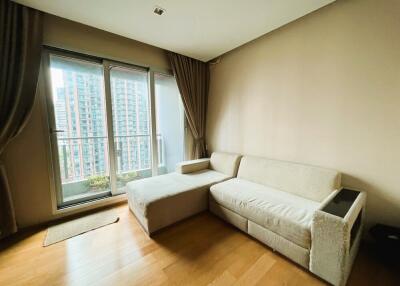 Living room with a sofa and large windows